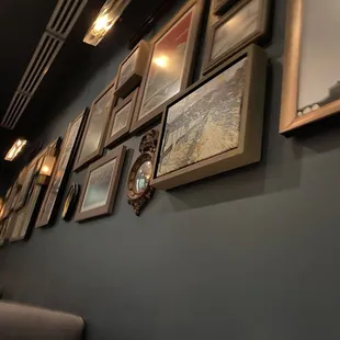 a row of framed photographs on a wall