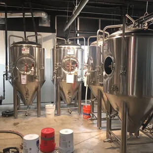 a row of stainless steel tanks