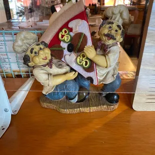 three figurines sitting on a table