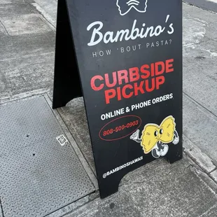 a sign on the sidewalk