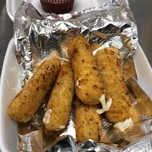 a plate of fried breaded breaded tots