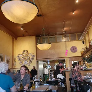 people sitting at tables in a restaurant
