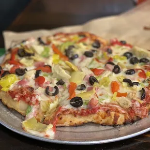 a pizza with olives and peppers