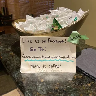 a sign that reads like us on facebook go to