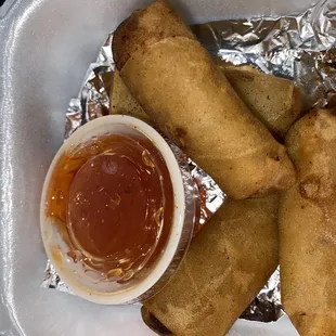 a plate of fried food with dipping sauce