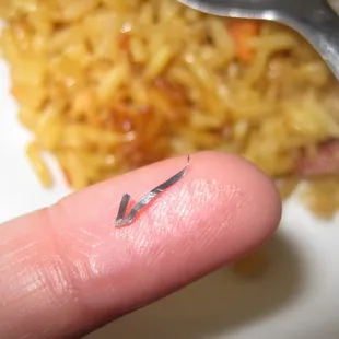 Pointy sharp metal found in pork fried rice.