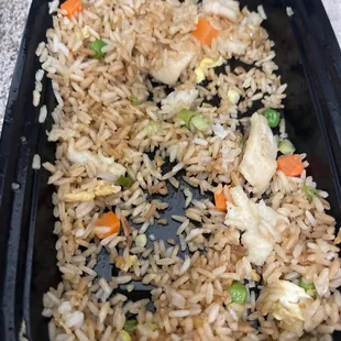 rice and vegetables in a black container