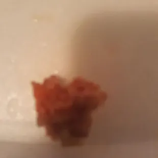 I found this in my fried rice looked and felt like it was chewed up and placed in the middle the fried rice disgust