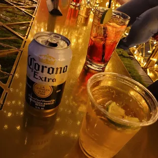 a can of corona beer and a glass of lemonade