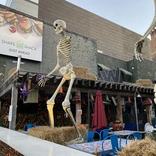 a skeleton in front of a restaurant