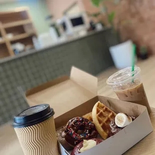 a cup of coffee and a box of waffles