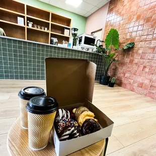 a box of donuts and a cup of coffee