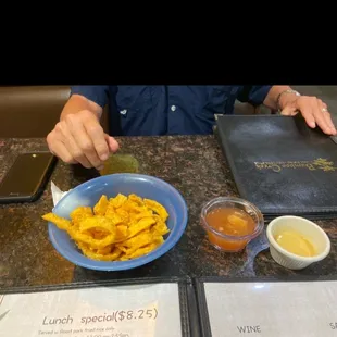 a plate of french fries and dipping sauces
