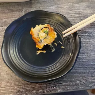 a plate of food with chopsticks