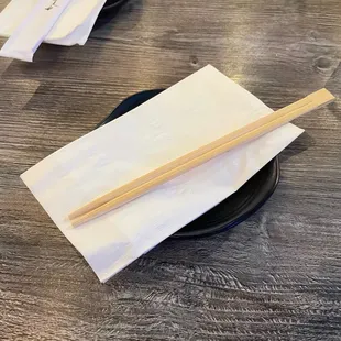 chopsticks on a plate on a table