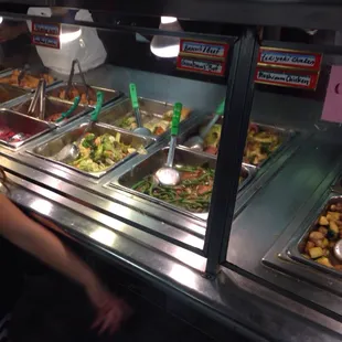 a woman standing in front of a buffet