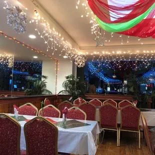 the interior of a restaurant decorated for christmas