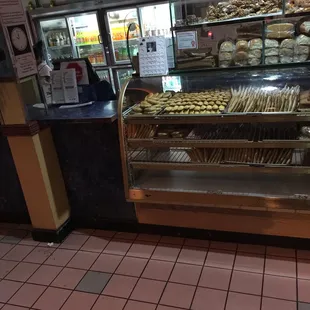a bakery counter with a variety of baked goods