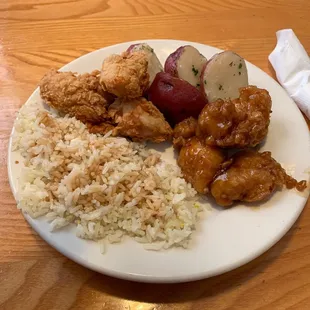 a plate of chicken, rice, and vegetables