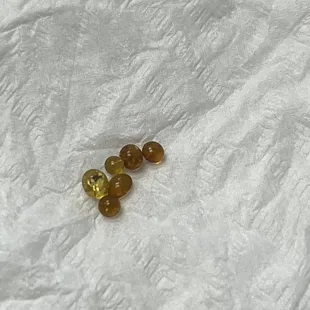 a pair of yellow and brown beads