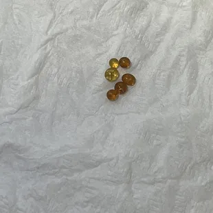 a single piece of food on a white tablecloth