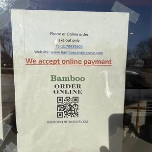 a sign posted on the door of a business