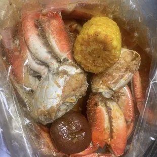 crab legs and potatoes in a plastic bag