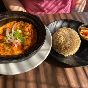 Claypot tofu stewed with house special spicy sauce, brown rice, and kimchi