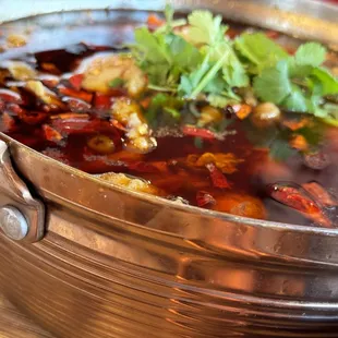a bowl of soup with a garnish on top