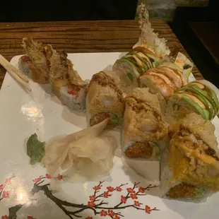 a plate of sushi with chopsticks