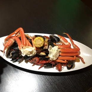 a plate of seafood and vegetables on a table