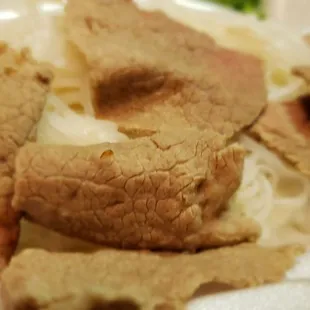 a close up of a plate of food in a styrofoam container