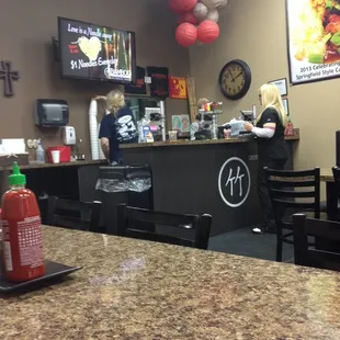 a restaurant with a counter and chairs