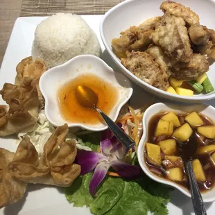 a plate of asian food and a bowl of rice
