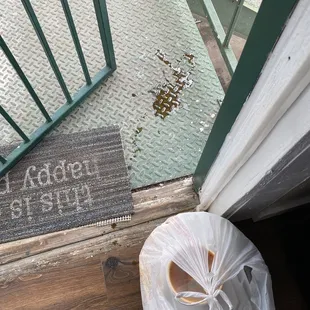 a bag of food on the floor next to a door