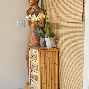 a statue of a woman holding a potted plant