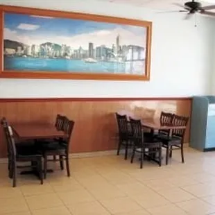 a dining room with a painting on the wall