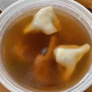 three dumplings in a broth soup