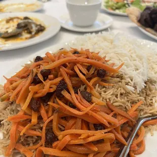 a plate of rice, carrots and raisins
