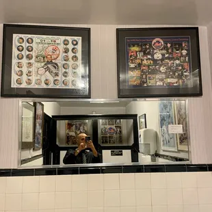 a man taking a picture of himself in the mirror