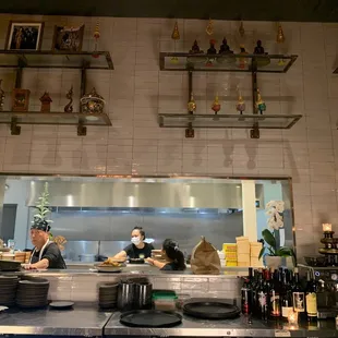 two people in a kitchen preparing food