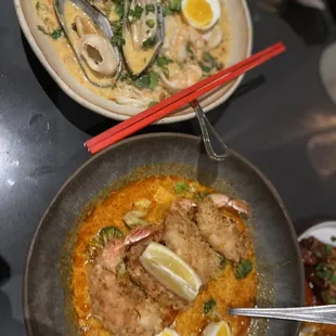 a bowl of soup and two plates of food