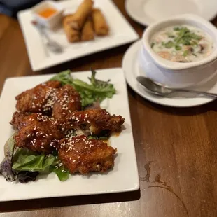 Sweet Chili Wings, coconut soup, and crispy rolls in the background