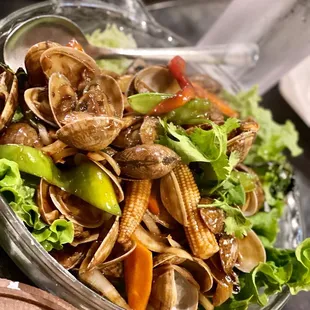 a bowl of clams and vegetables