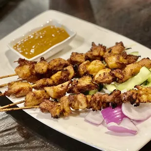 skewered food on a white plate