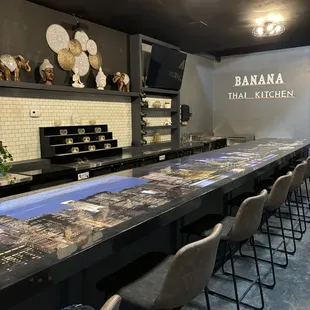 a long bar with chairs