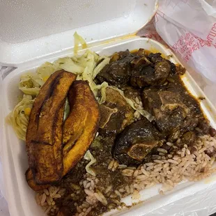 Oxtail plate, rice and peas, Fried Plantain, and cabbage