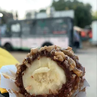 a person's hand holding a pastry