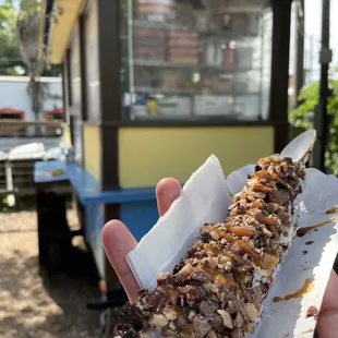 a hand holding a banana crispy snack