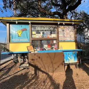 a food stand with a blue and yellow awning